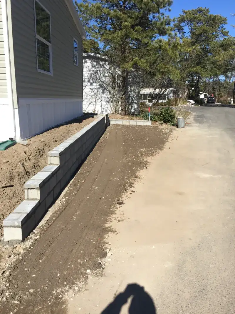 Asphalt and Stone Wall Repair - Before